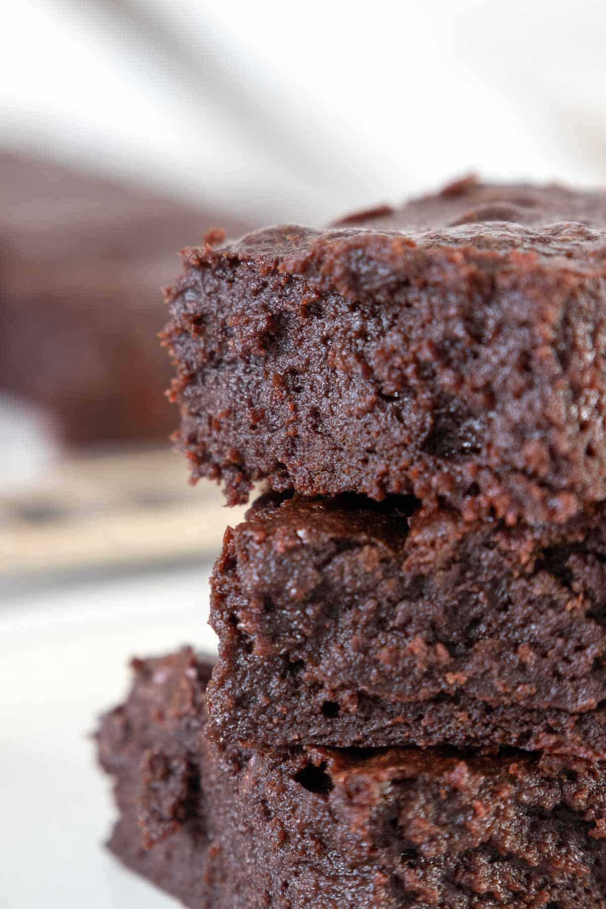 Close up of three stacked brownies.