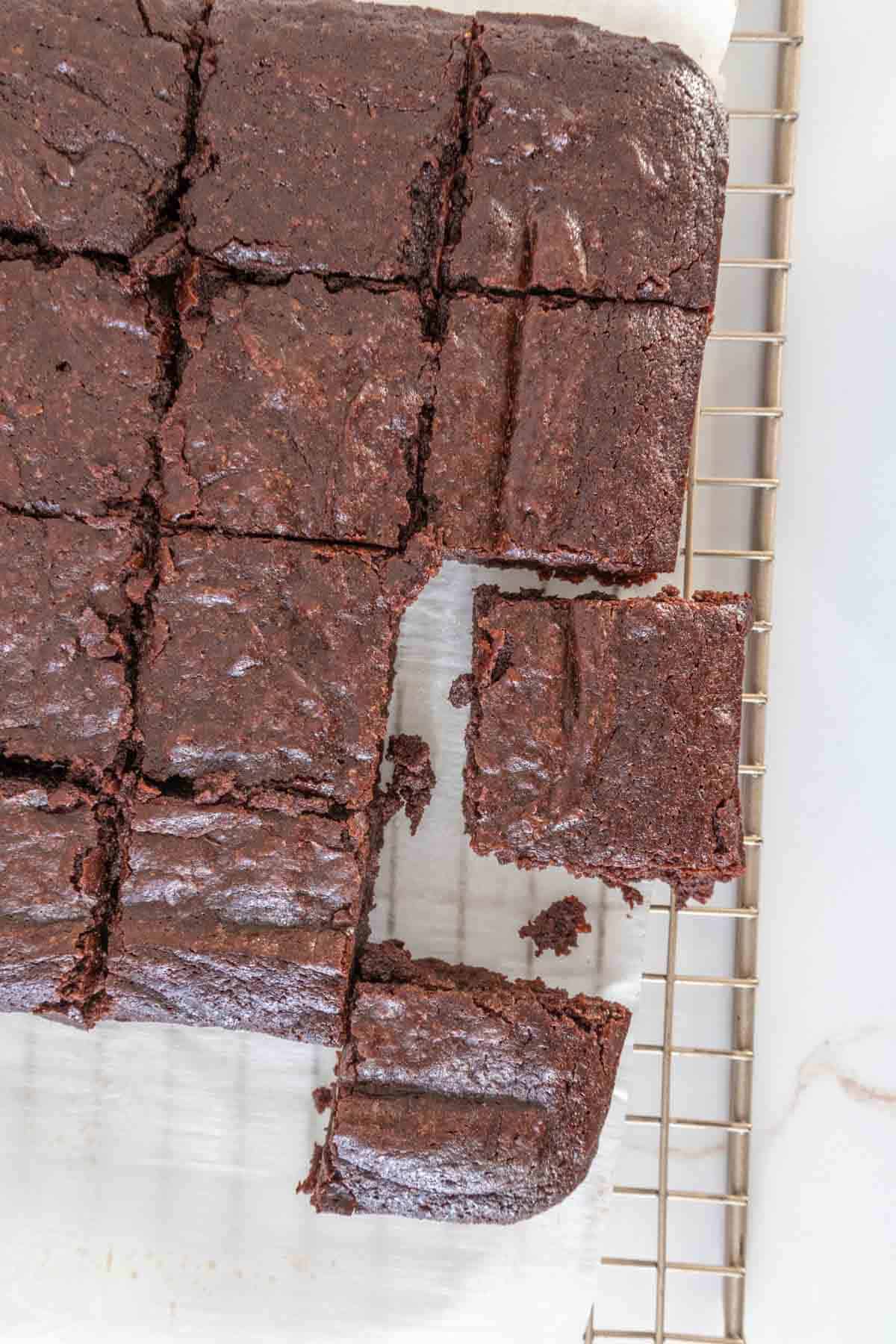 Overhead of sliced fudgy brownies on a cooling rack.
