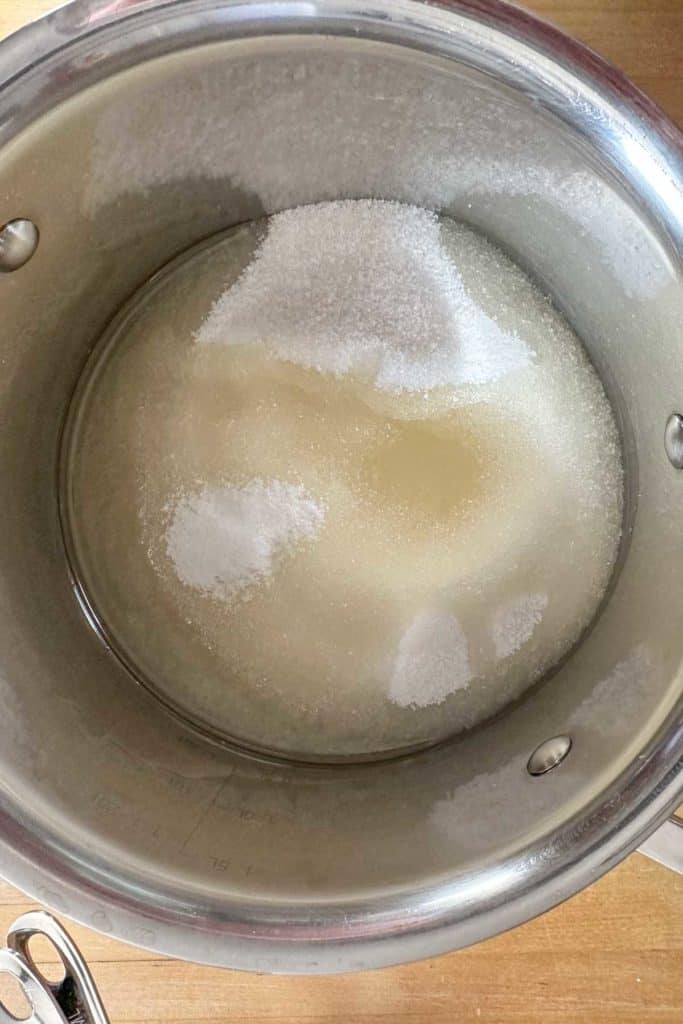 Sugar, oil, salt, and water in a saucepan before heating.