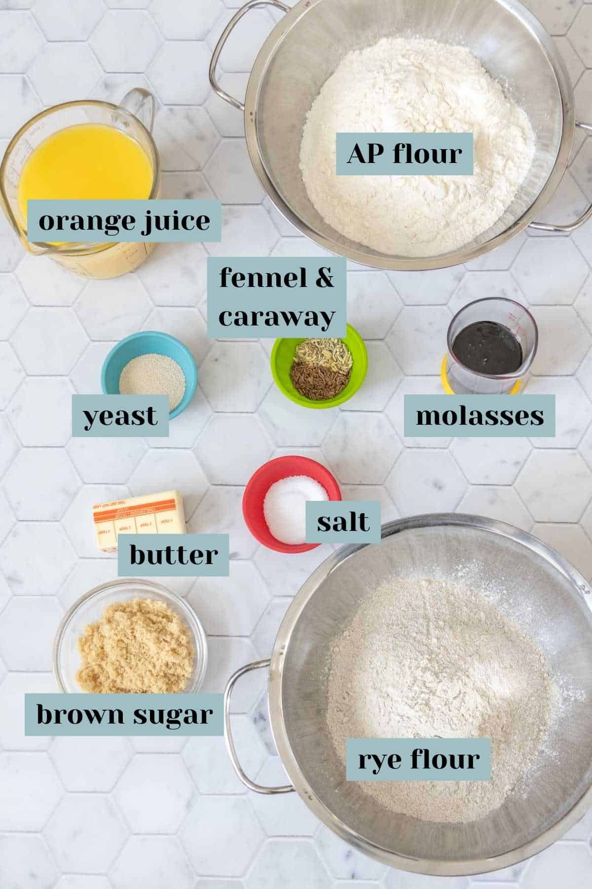 Ingredients for limpa bread on a tile surface with labels.