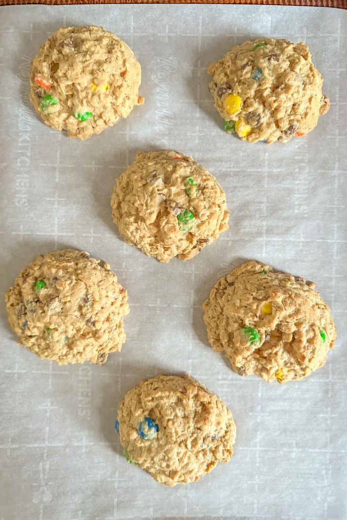 Baked monster cookies on baking sheet.