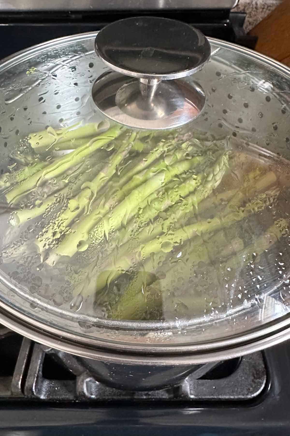 Steaming asparagus in a pot with the lid on.