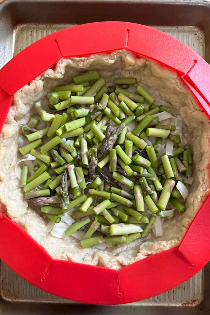 Asparagus added to a parbaked pie crust for quiche.