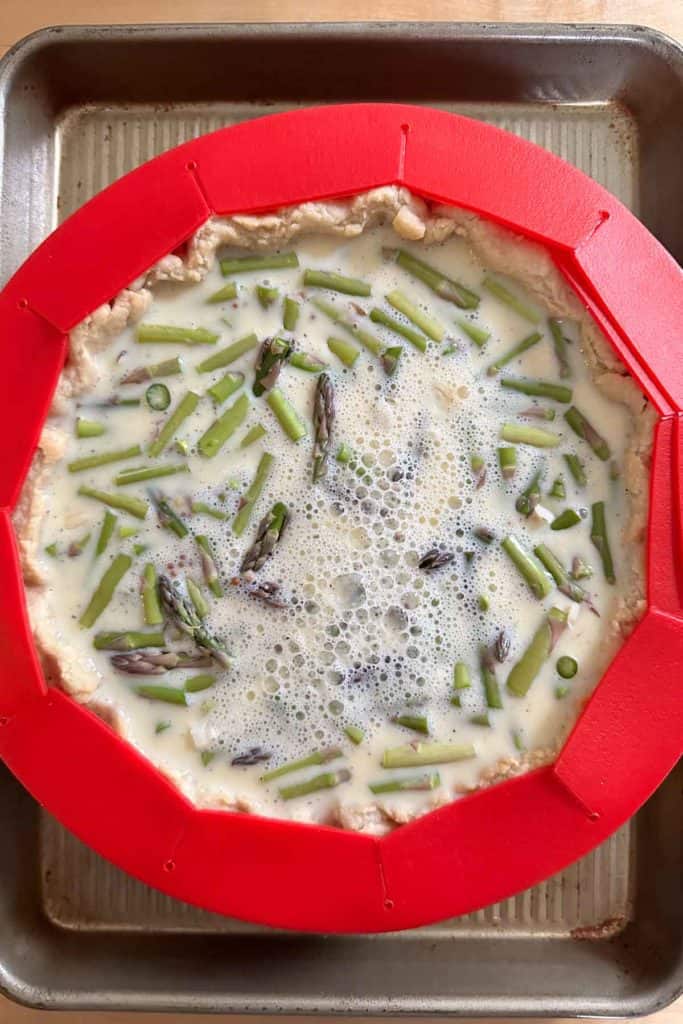 Unbaked asparagus quiche.