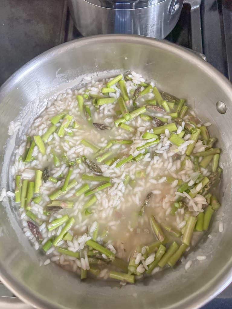 Cooking asparagus risotto on the stove.