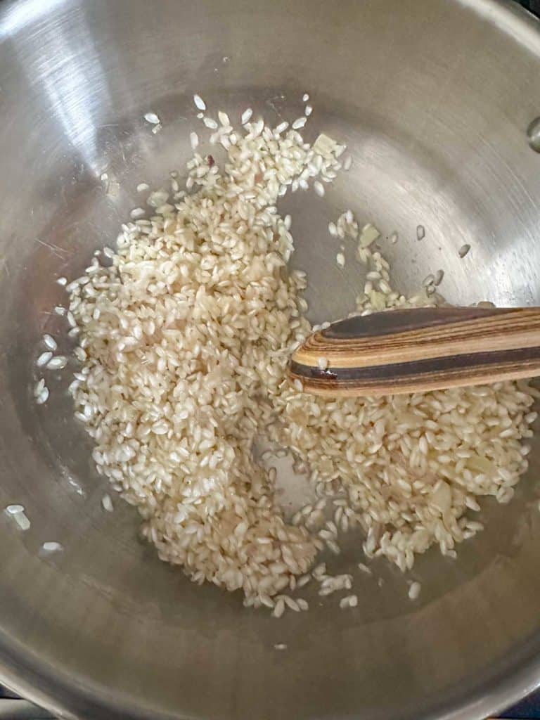 Toasting arborio rice in pan for risotto.
