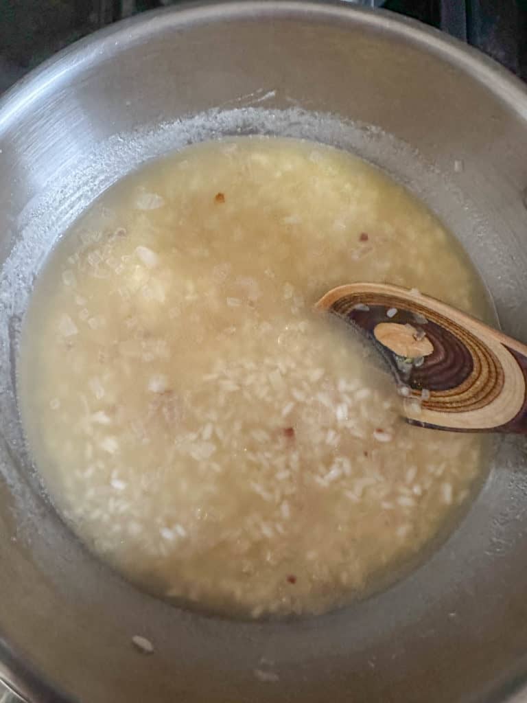 Stirring risotto in pan.