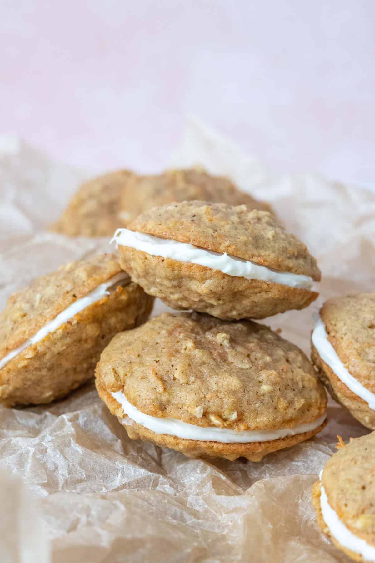Pile of carrot cake cookies on parchment paper.