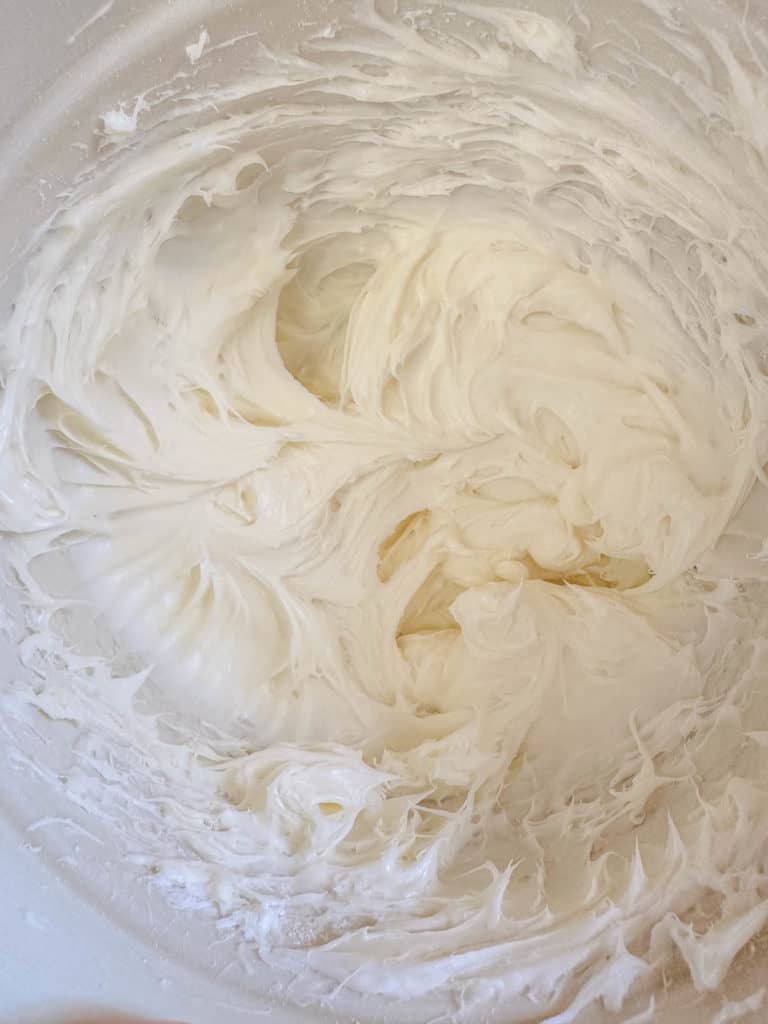 Cream cheese frosting in a mixing bowl.