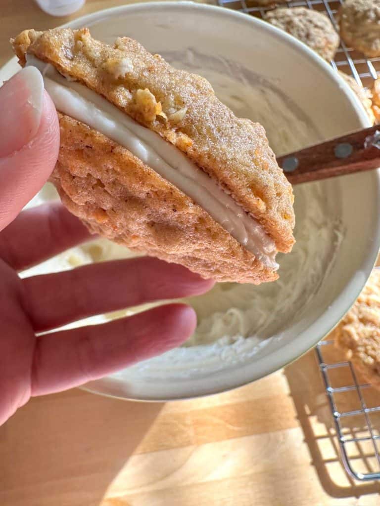 Sandwiched carrot cake cookies with cream cheese frosting.