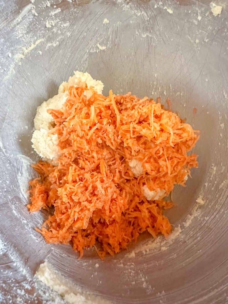 Carrots being added to butter and sugar mixture.