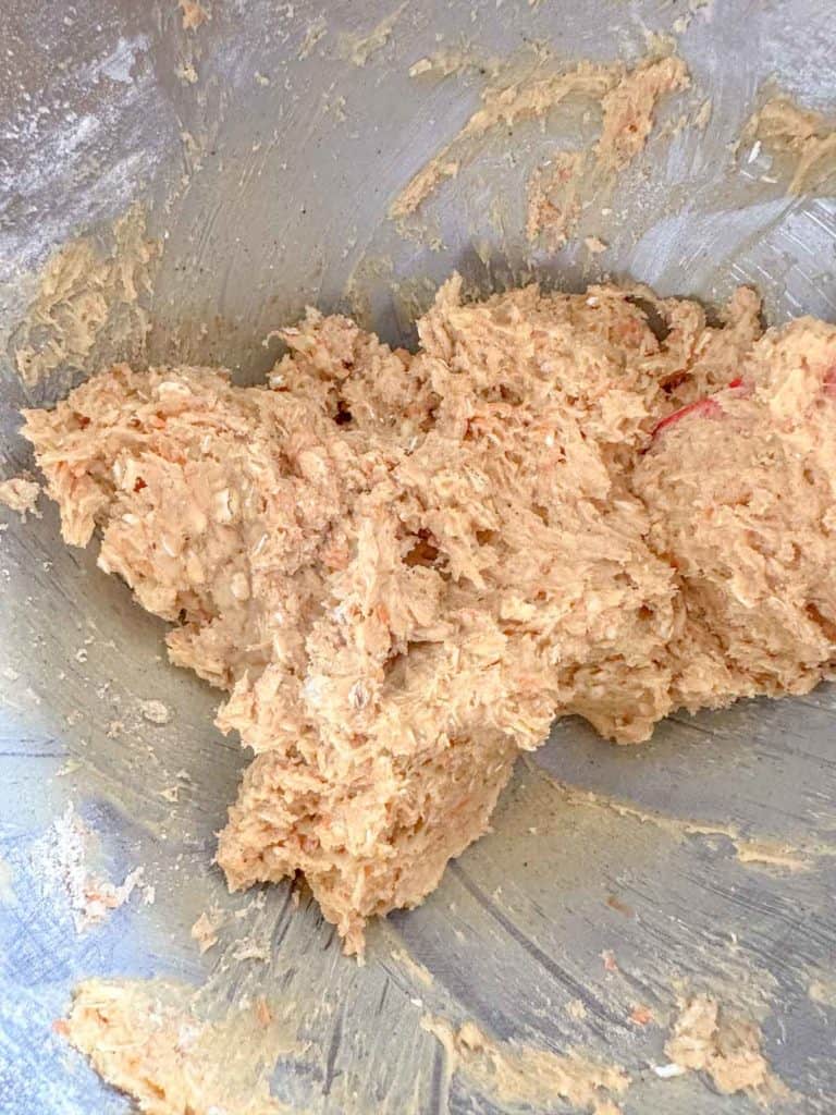 Mixed carrot cake cookie dough in a bowl.