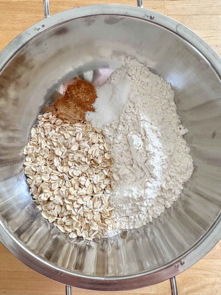 Dry ingredients for carrot cake cookies in a mixing bowl.