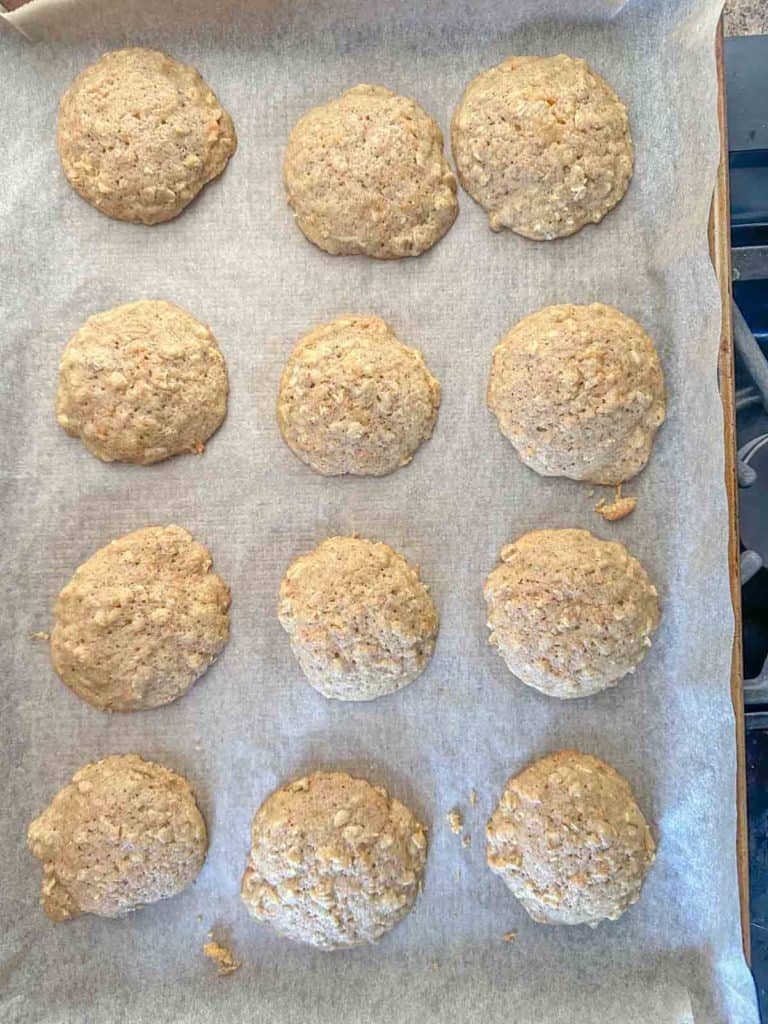 Baked carrot cake cookies on a sheet pan.