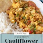 Cauliflower curry served with rice on a plate.