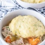 Low bowl filled with chicken and dumplings.