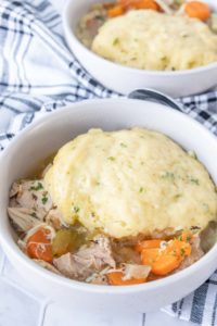 Low bowl filled with chicken and dumplings.