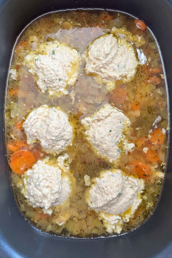 Drop biscuit dough added to crock pot for chicken and dumplings.