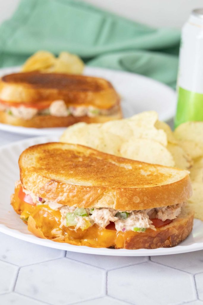 Tuna melt sandwich on a white plate.
