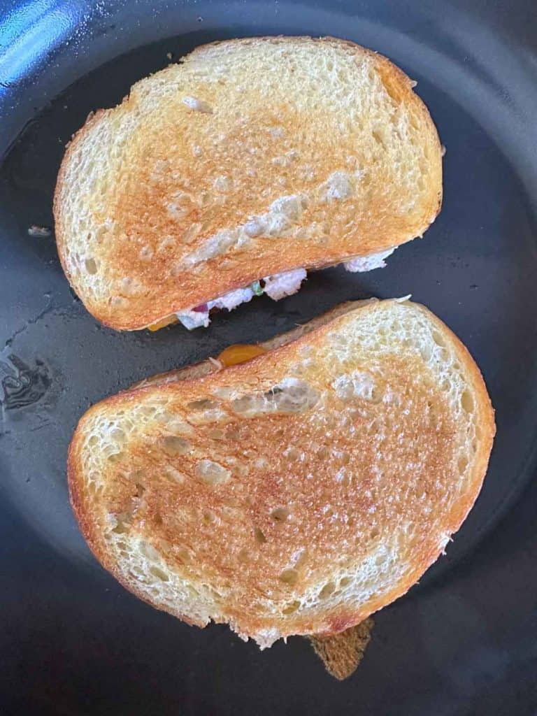 Cooked tuna melts in frying pan.