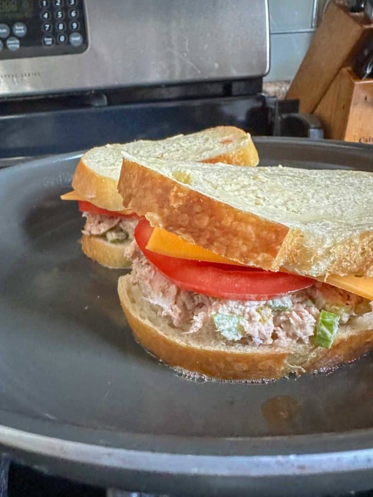 Tuna melts cooking in frying pan.