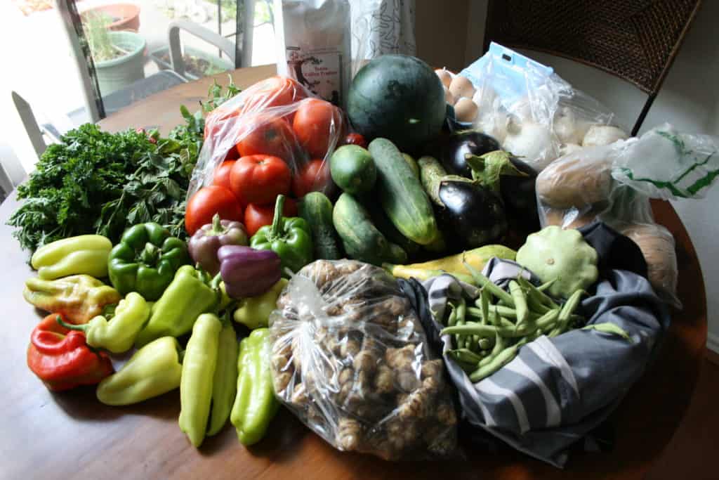 Fresh produce from CSA box on a table.