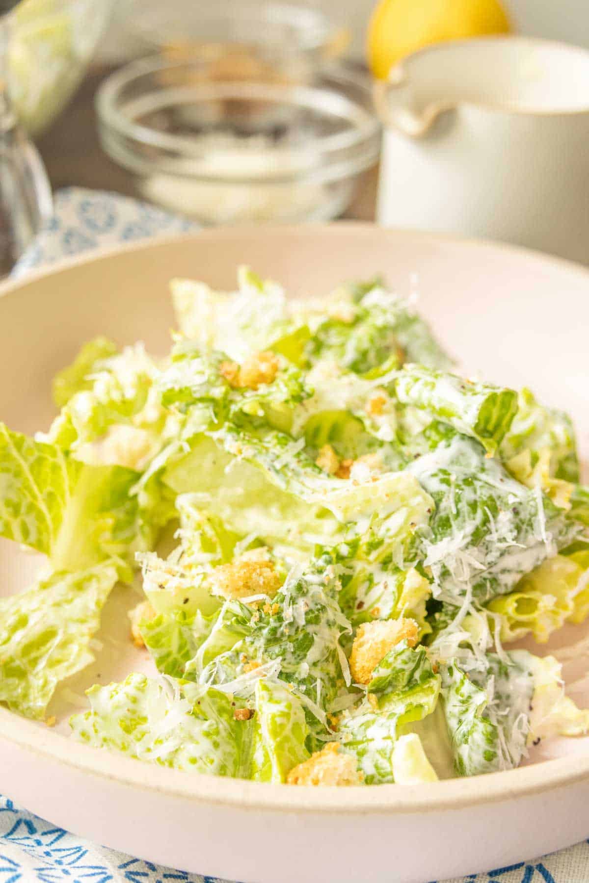 Caesar salad on a pink plate.