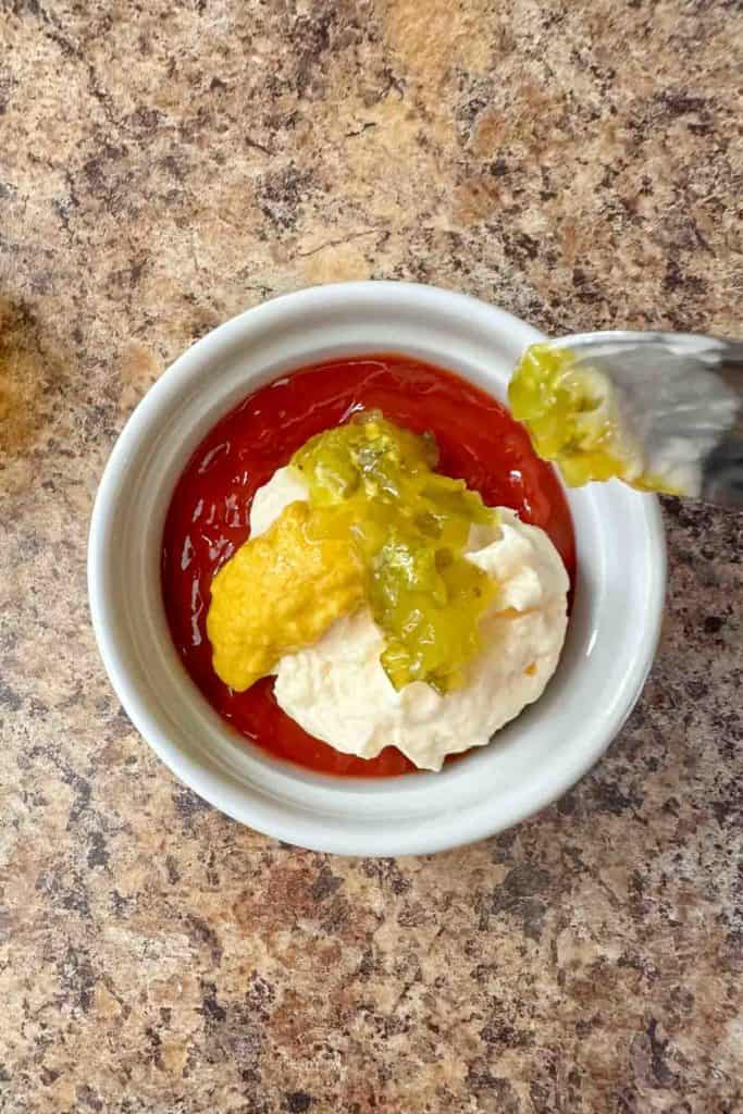 Ingredients for homemade burger sauce in a white bowl.