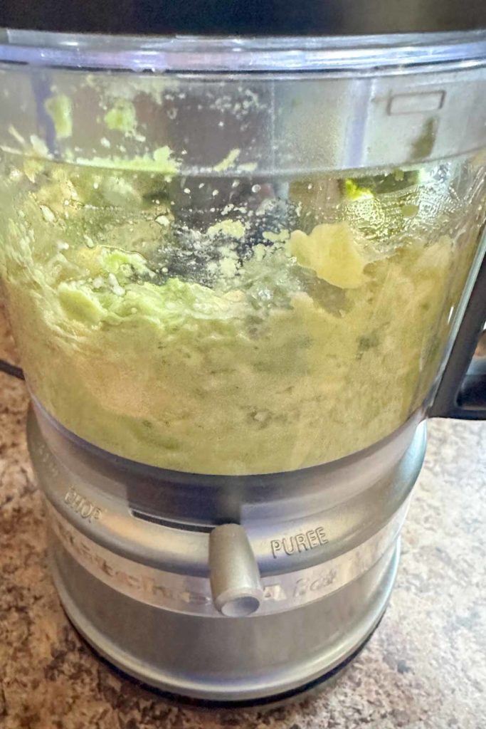 Pureeing avocado in a food processor.