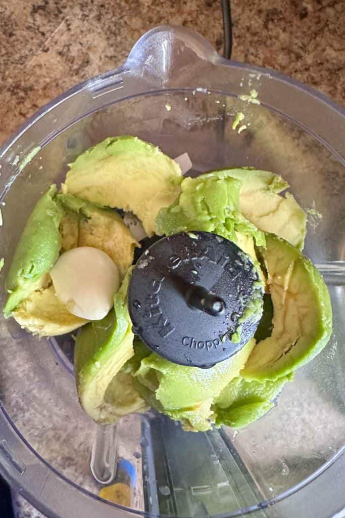 Avocado, garlic, and lemon juice in a food processor.