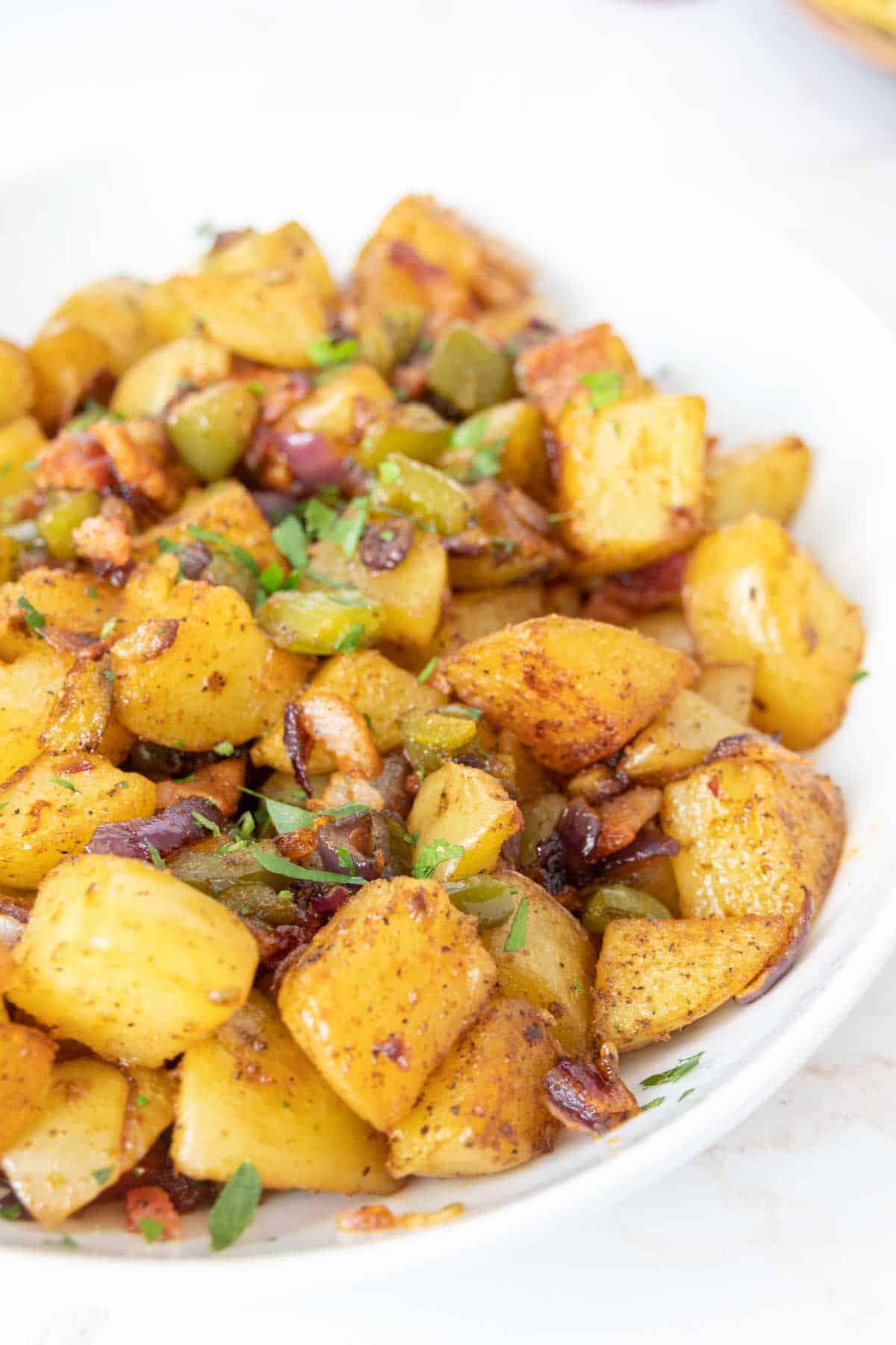 Close up of serving bowl full of roasted breakfast potatoes.