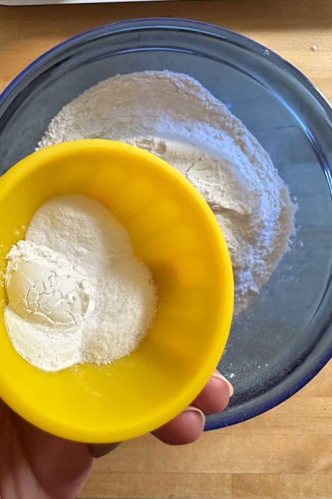 Adding dry ingredients together for muffins.