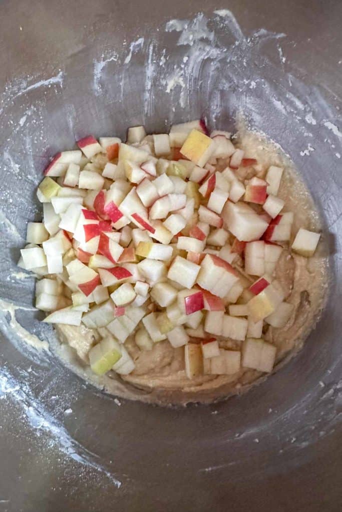 Apples added to muffin batter before stirring.