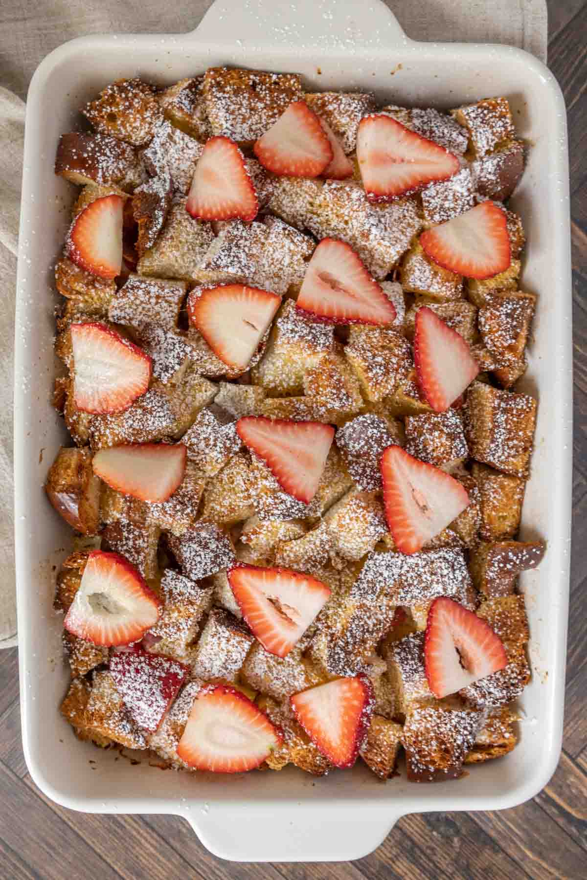 White casserole dish of baked strawberry french toast.