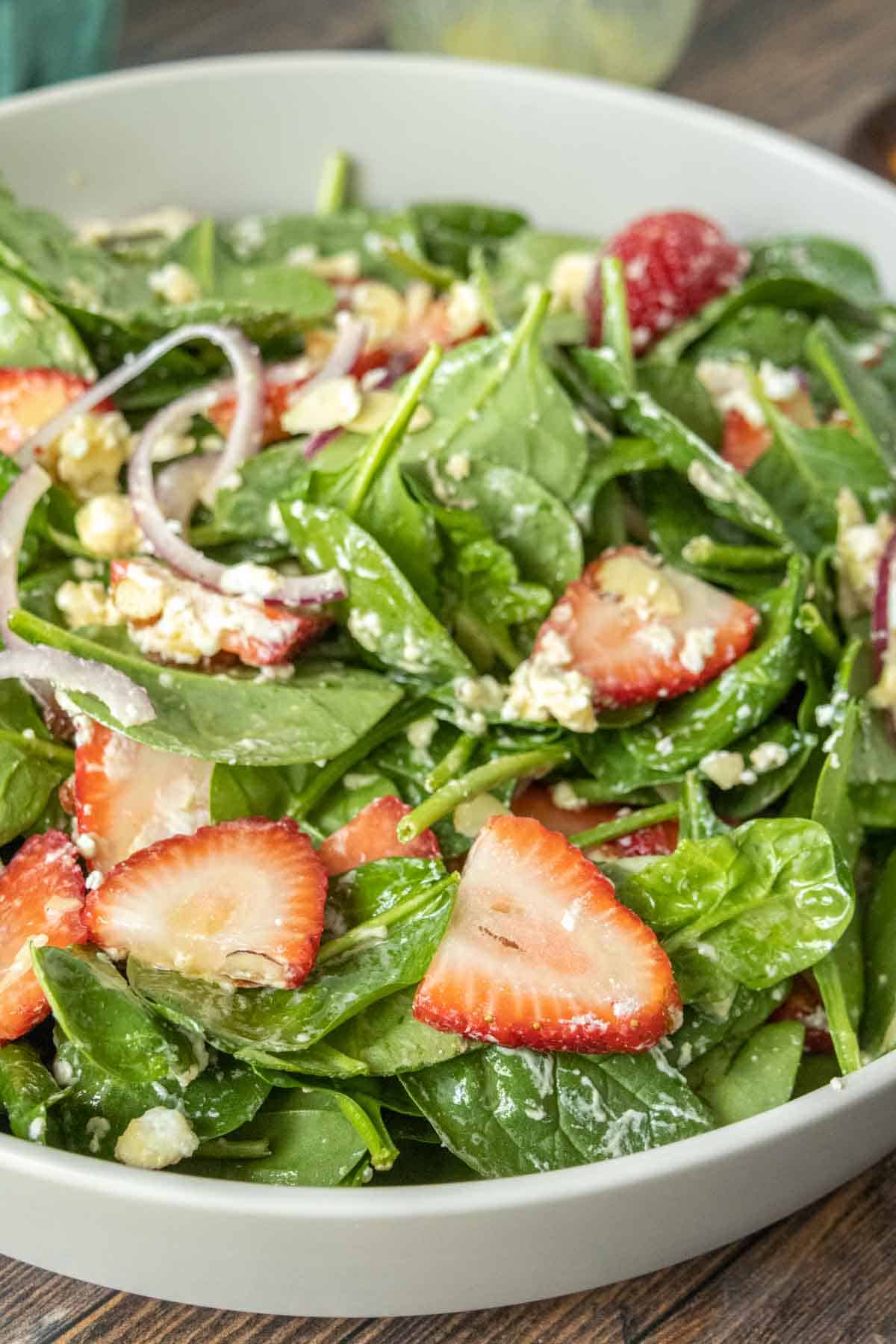 Serving bowl of strawberry spinach salad.