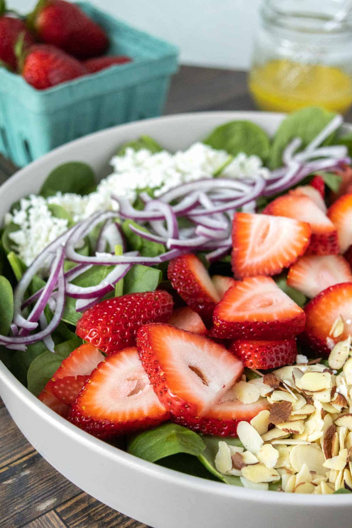 Strawberry spinach salad in a large serving bowl.