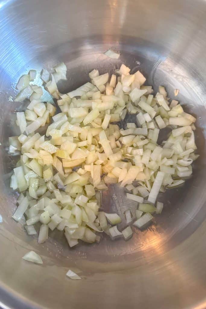 Sauteeing chopped onion in a pan.