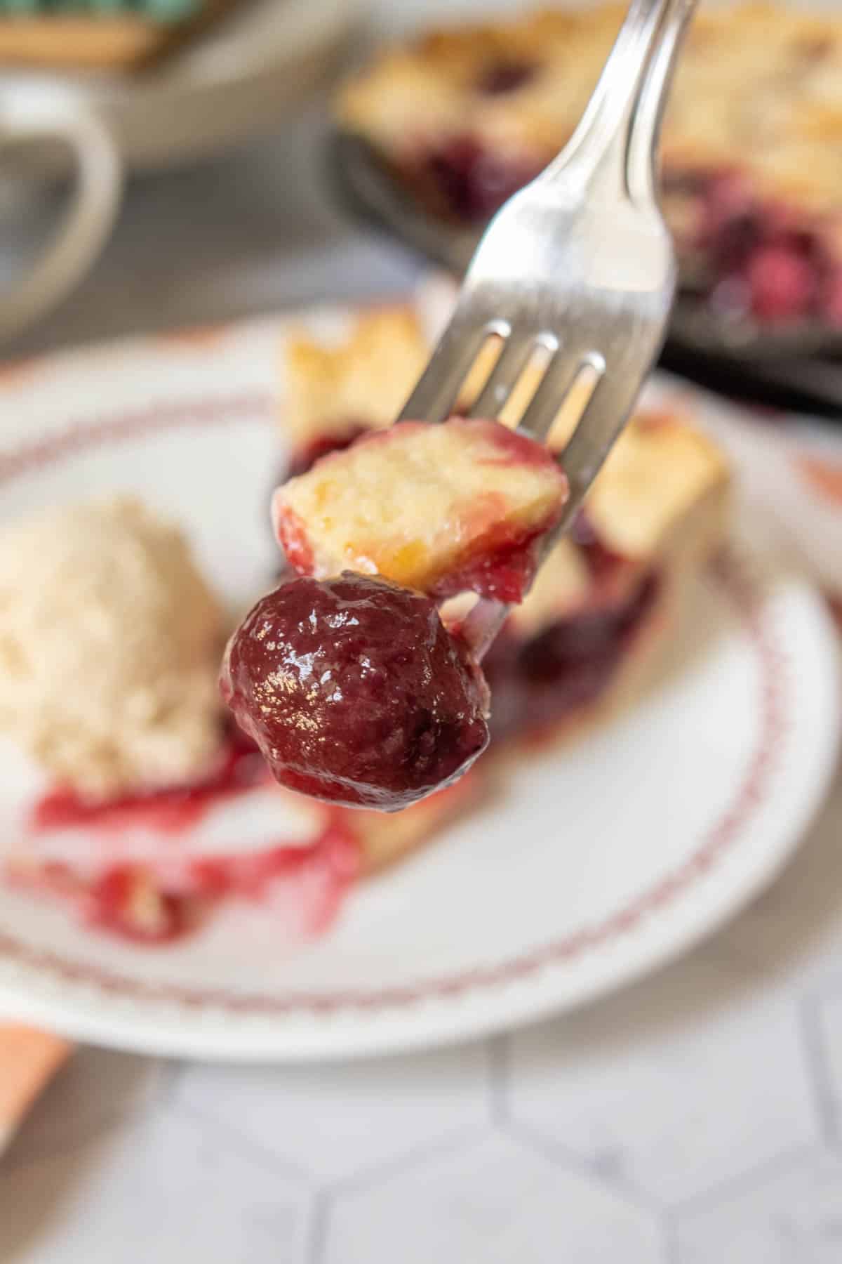 Forkful of cherry pie close up.