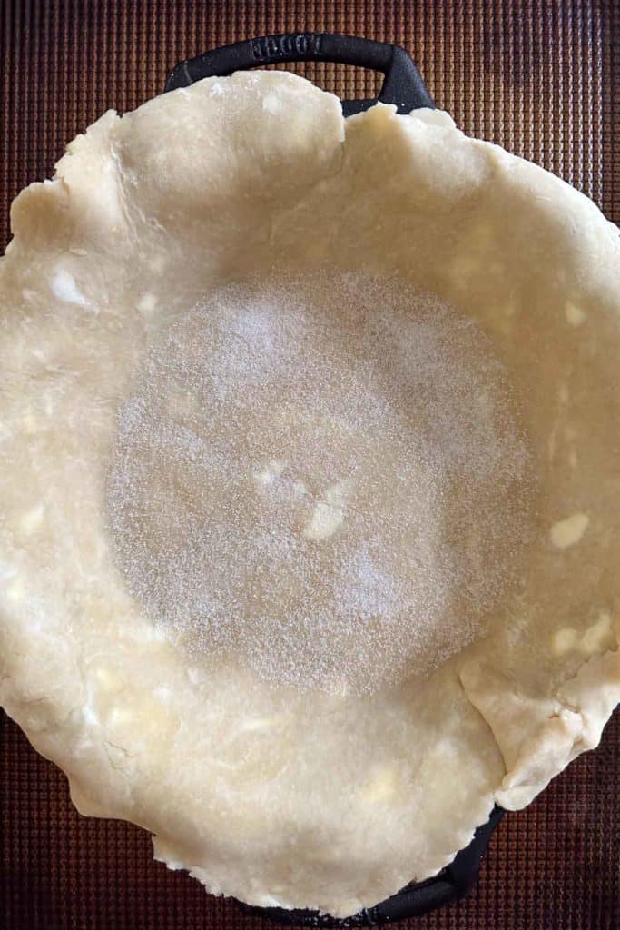 Sugar on bottom of unbaked pie crust.