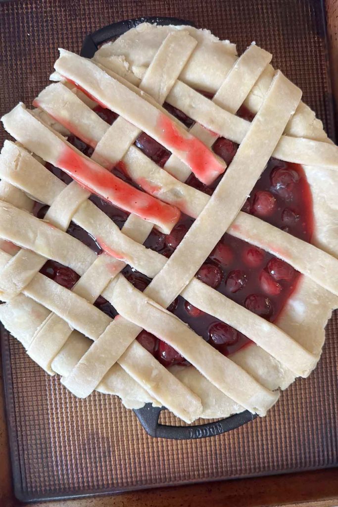 Placing strips of pie dough for lattice top.