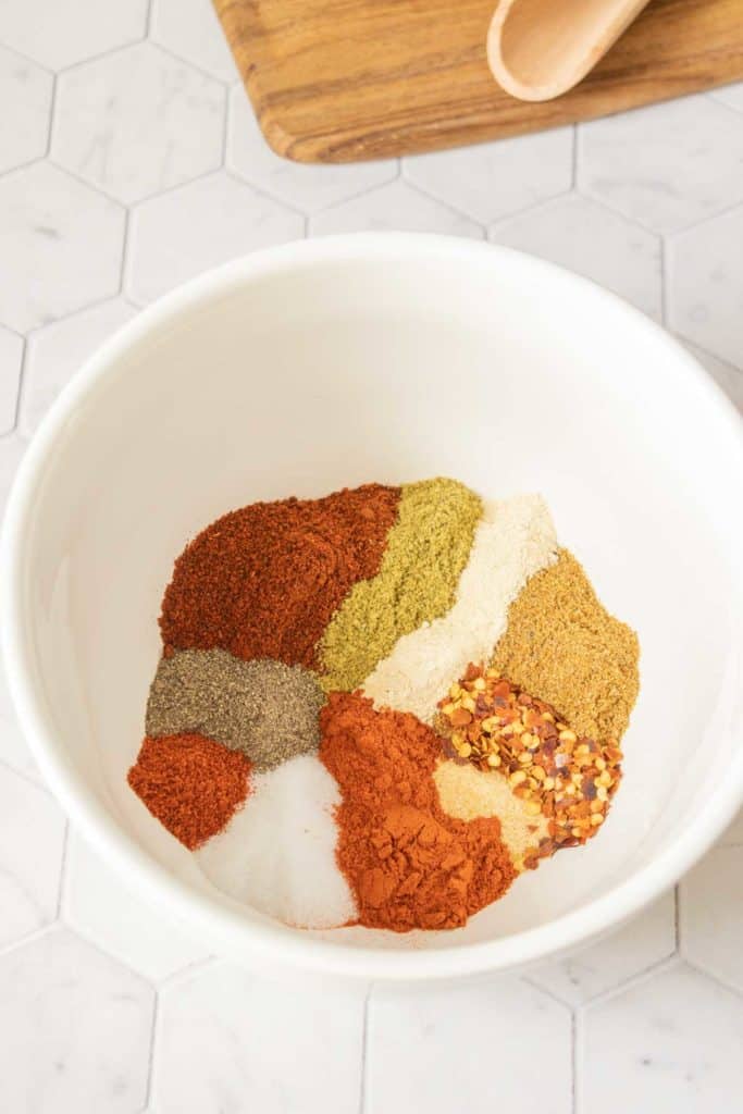 Ingredients for homemade taco seasoning in a bowl before being mixed.