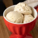 Red ice cream bowl with three scoops of no-churn ice cream.