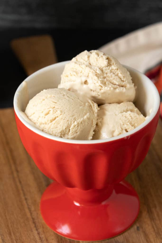 Red ice cream bowl with three scoops of no-churn ice cream.