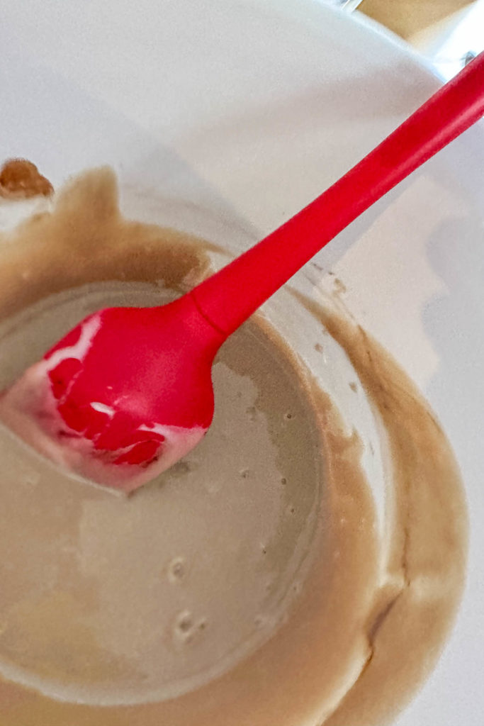 Sweetened condensed milk mixed with vanilla in a bowl.