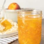 Mason jar of homemade peach jam.