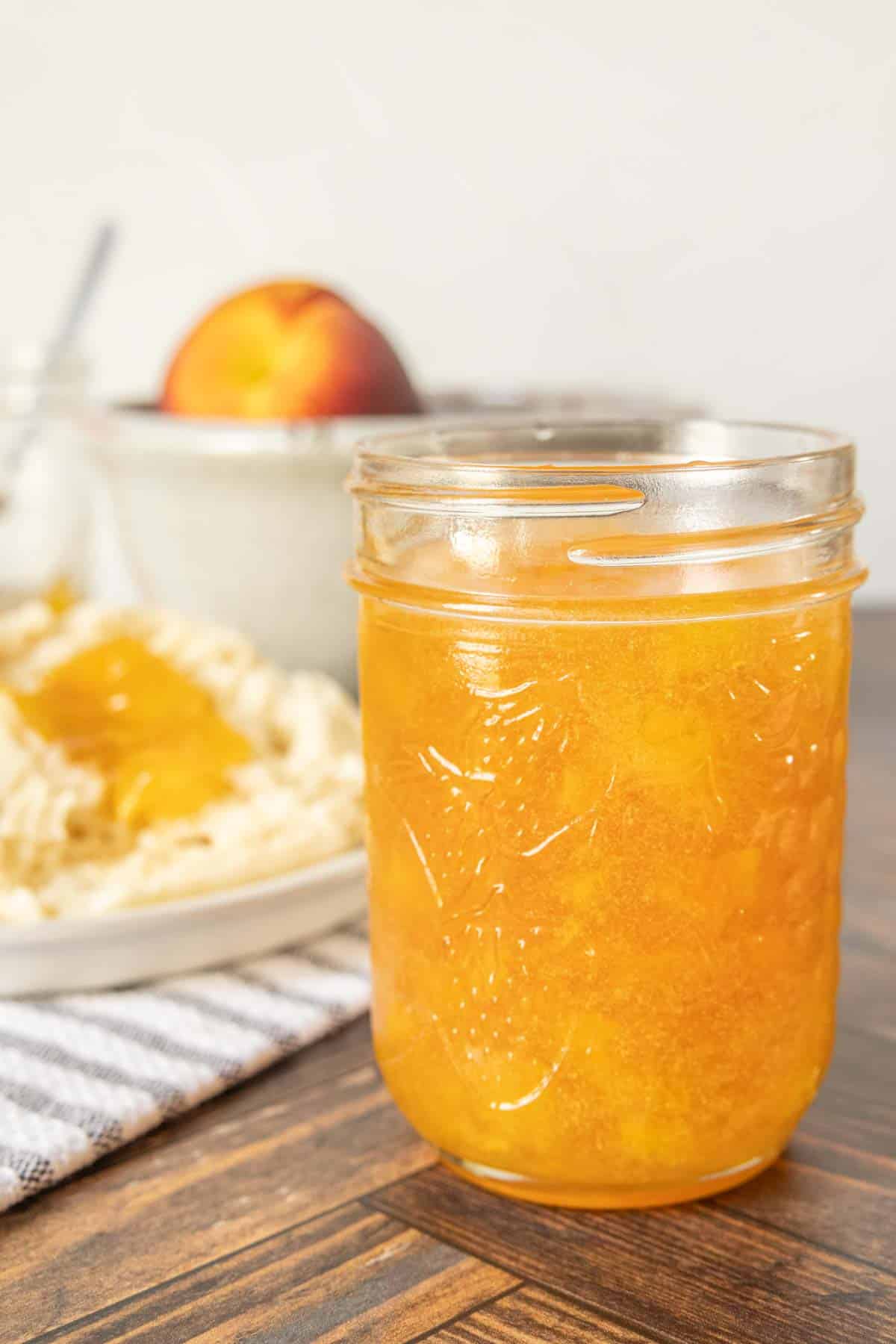 Mason jar of homemade peach jam.