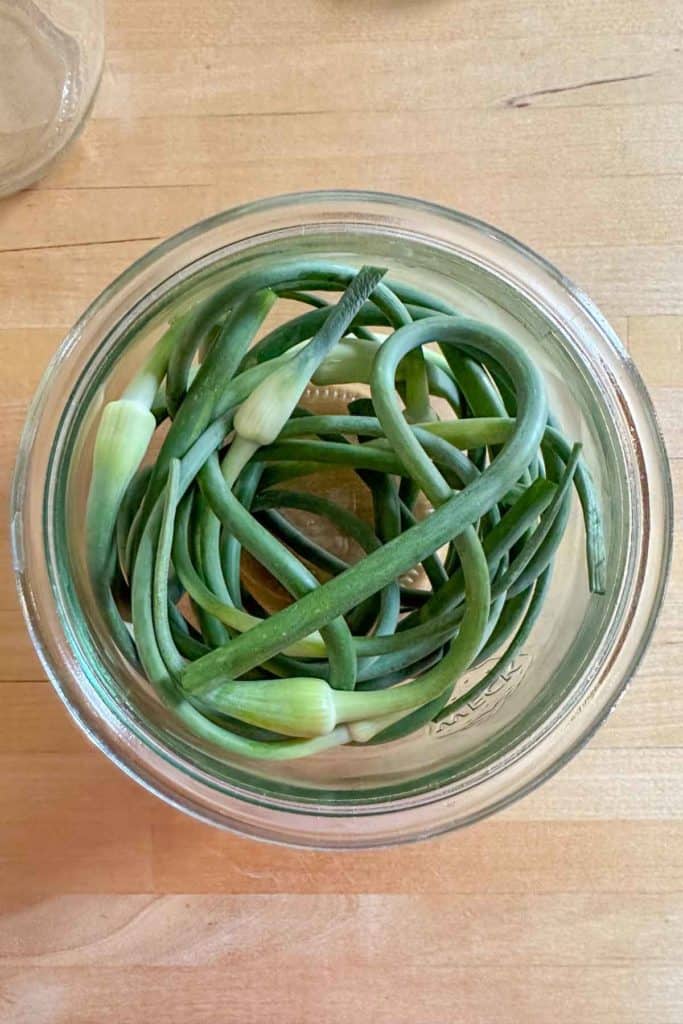 Garlic scapes in a glass jar.