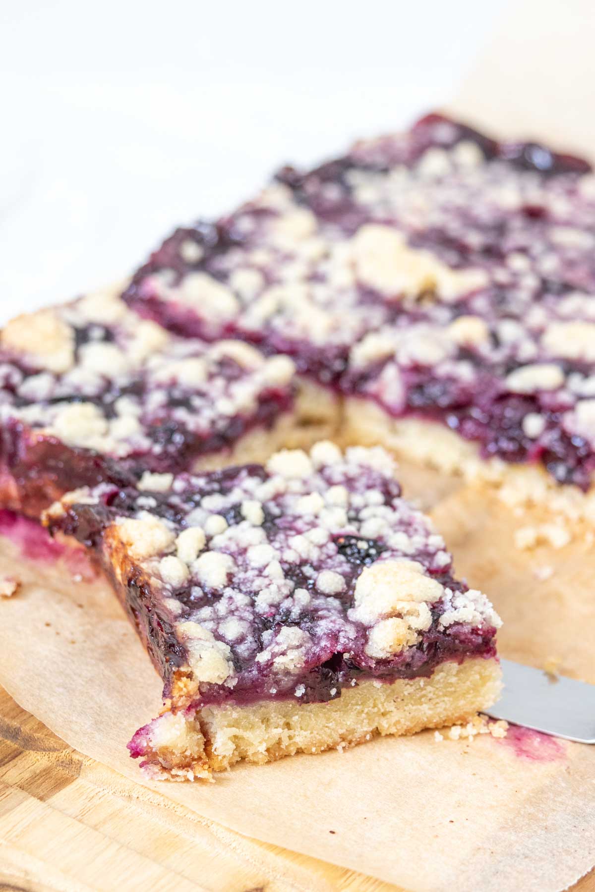 Cut blueberry pie bars on parchment paper.