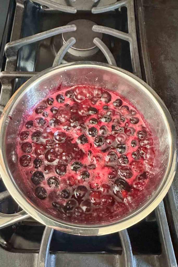 Blueberry bar filling cooking in a saucepan.