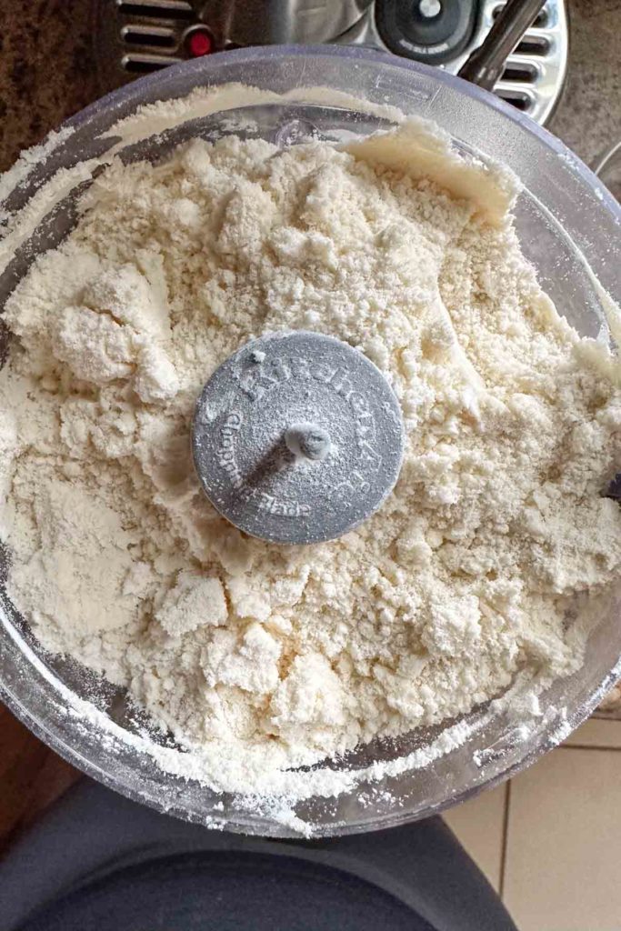 Flour, sugar, and butter mixed together in food processor.